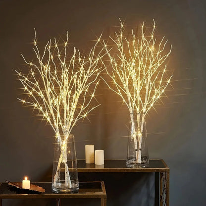 LED Illumination BrightBranch - Yelopi - Two Birch Trees with LED light on, each inside a vase, each one on a table.