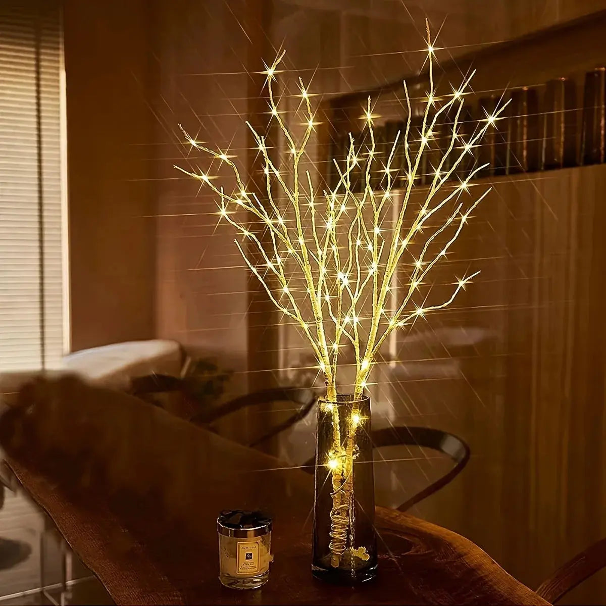 LED Illumination BrightBranch - Yelopi - two Birch treesuet with LED light on, inside a vase on a table in a livingroom.